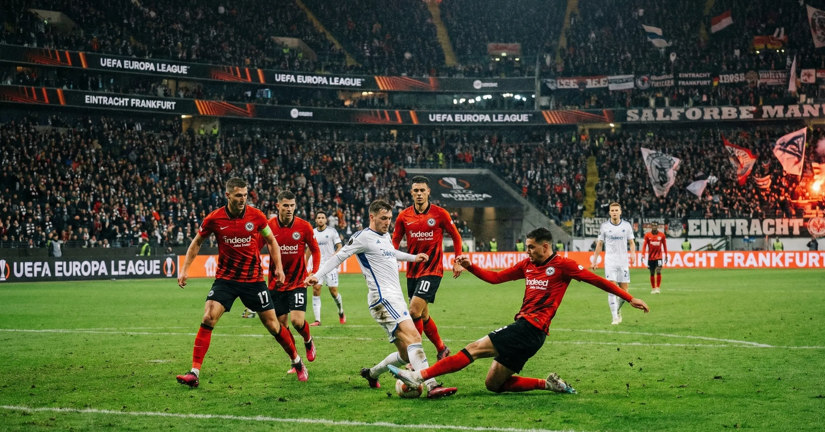 Football players competing in European competition match under stadium floodlights