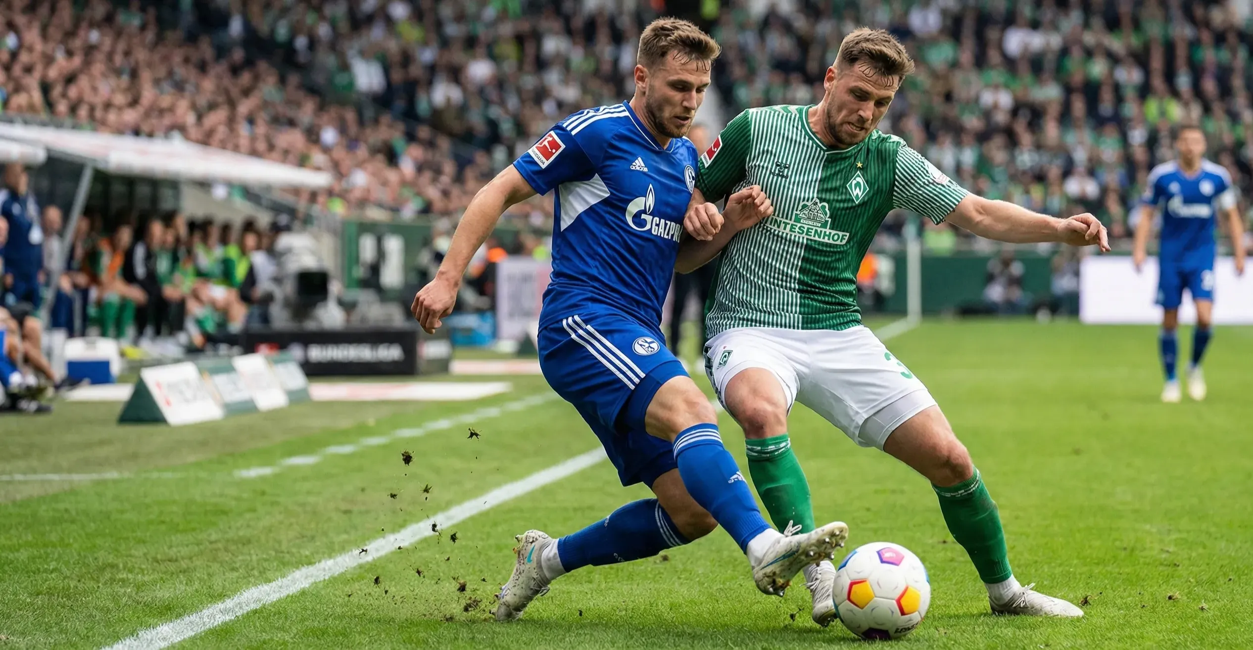 Football players from two teams competing for the ball in attacking third of the pitch